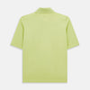 View 3 of product The Turnbull & Asser Lime Green Polo Shirt features a cotton jersey build, short sleeves, a collar, three brown buttons on the placket, and a chest pocket with a button. Shirt shown laid flat on a white background.