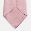 View 4 of product The Turnbull & Asser PINK PLAIN SATIN SILK TIE is neatly rolled and showcased against a plain white background.