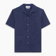 The Navy Silk Holiday Fit Phillips Shirt by Turnbull & Asser features short sleeves, a revere collar, and three front patch pockets, shown laid flat on a white background.