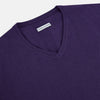 View 2 of product The Turnbull & Asser Purple Cashmere V-neck Jumper features long sleeves with ribbed cuffs and hem—a classic knitwear piece for effortless layering, shown against a white background.