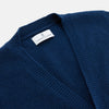 View 4 of product A man with a shaved head wears a Turnbull & Asser Navy Sleeveless Cashmere Cardigan over a white dress shirt with rolled-up sleeves and dark trousers, standing against a plain light gray background.