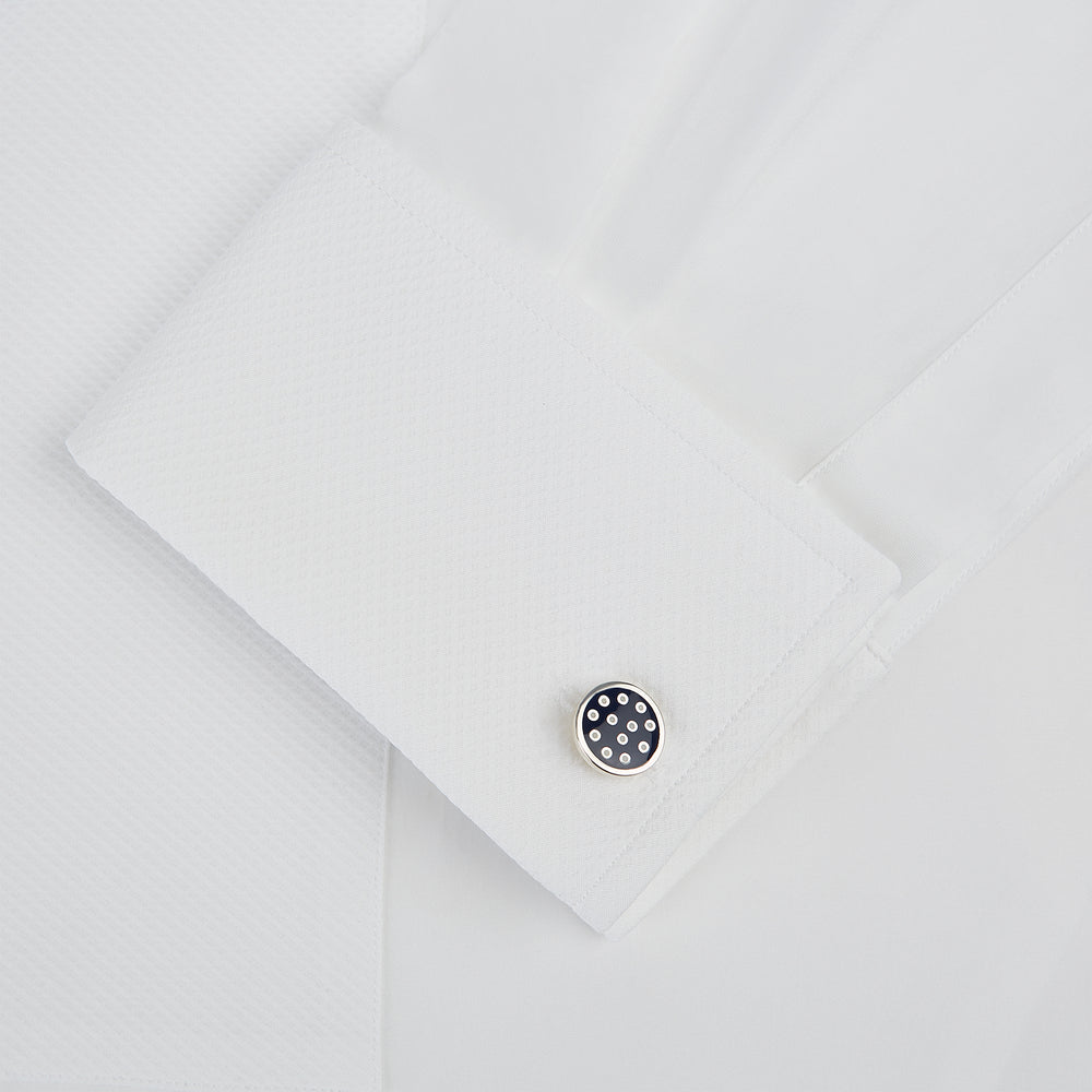 The Turnbull & Asser Navy Spotted Circle Enamel Cufflinks feature round faces with silver polka dots, offering a classic men's accessory in a striking navy design.