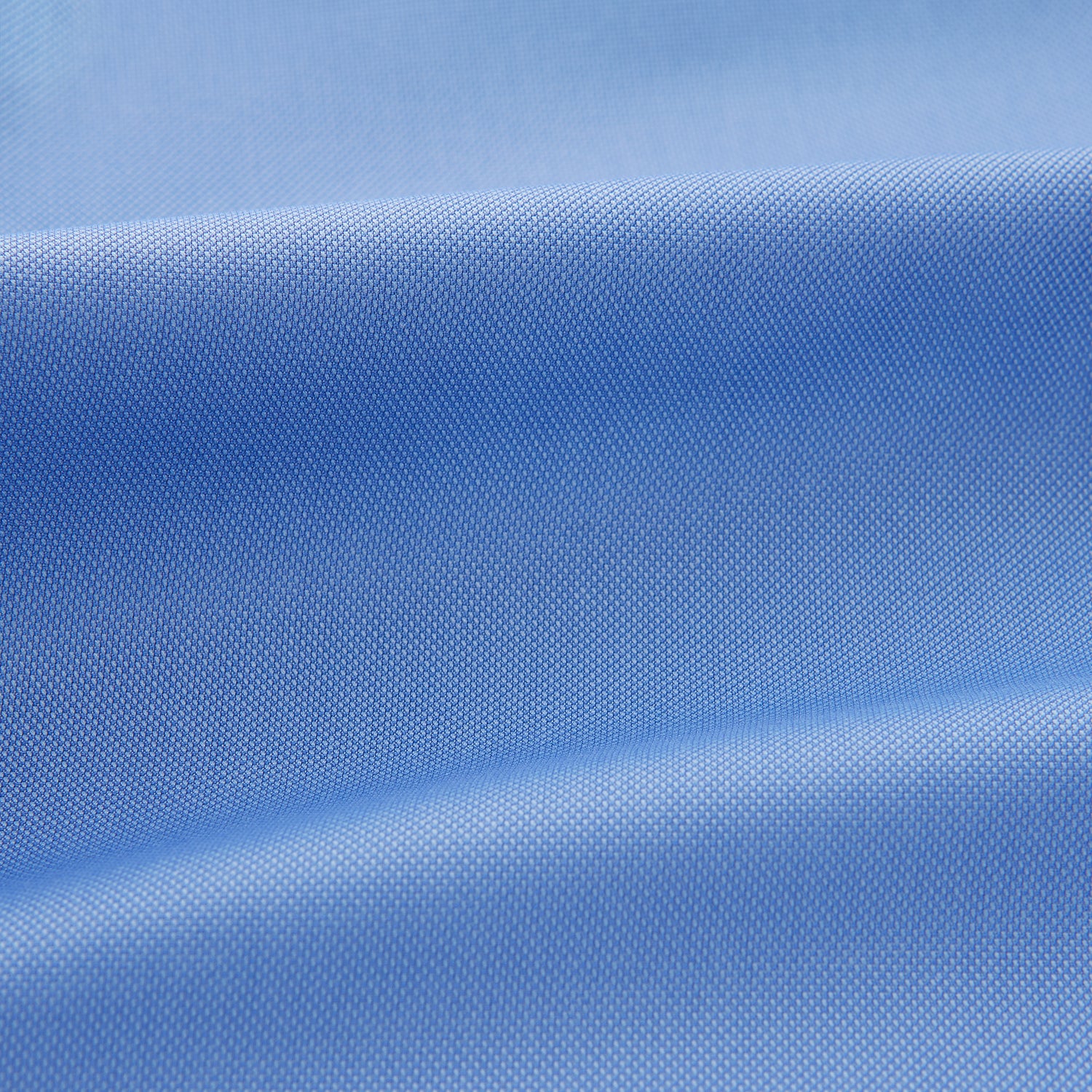 View 4 of product The Turnbull & Asser "The World Is Not Enough" blue cotton Istanbul shirt, as seen on James Bond, is a light blue oxford long-sleeve button-up with a pointed collar and white buttons, displayed on a white background.
