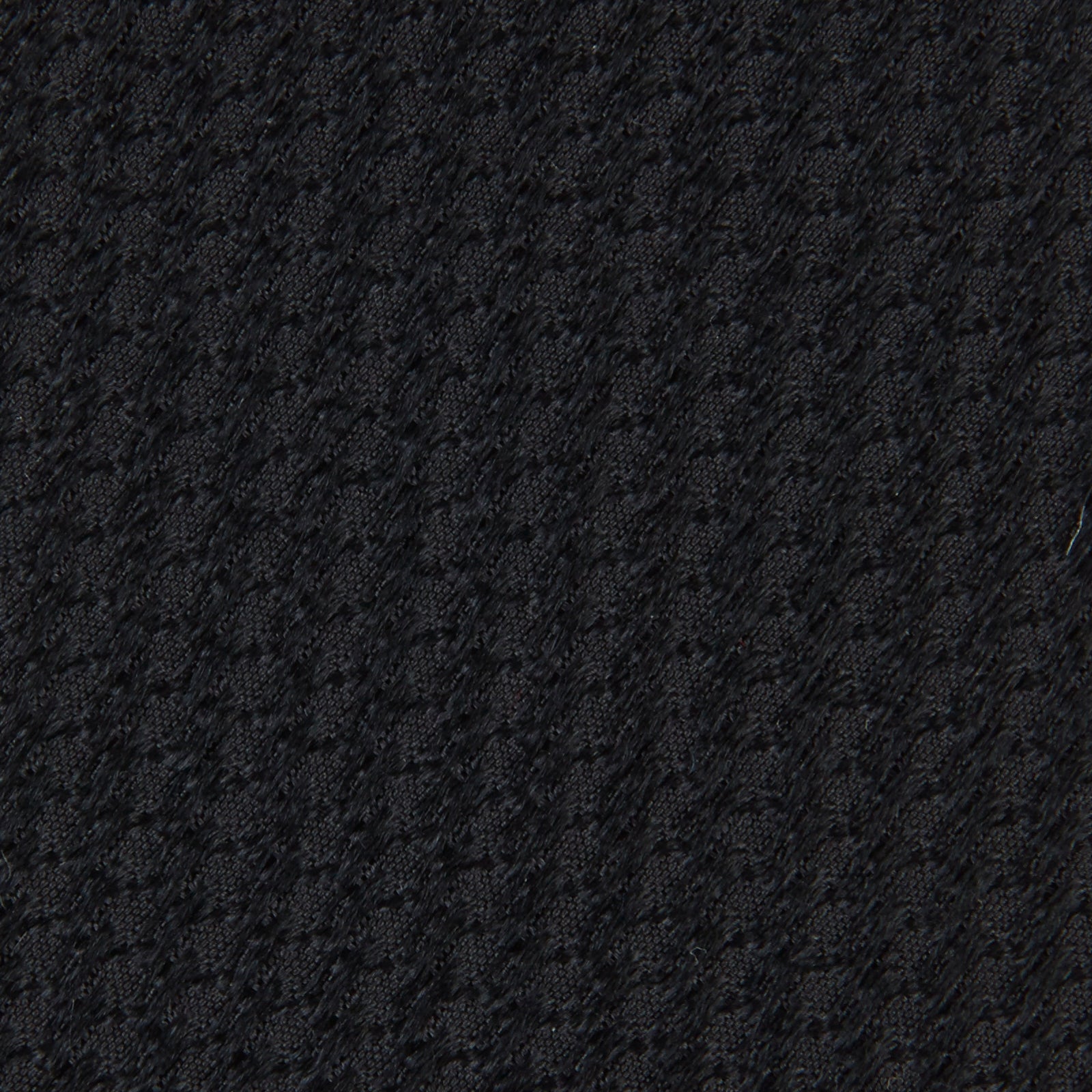 View 3 of product Turnbull & Asser's Seven-Fold Black Lace Silk Tie, featuring a textured finish and pointed tip, is elegantly rolled and displayed on a white background—a timeless accessory for any luxury neckwear collection.