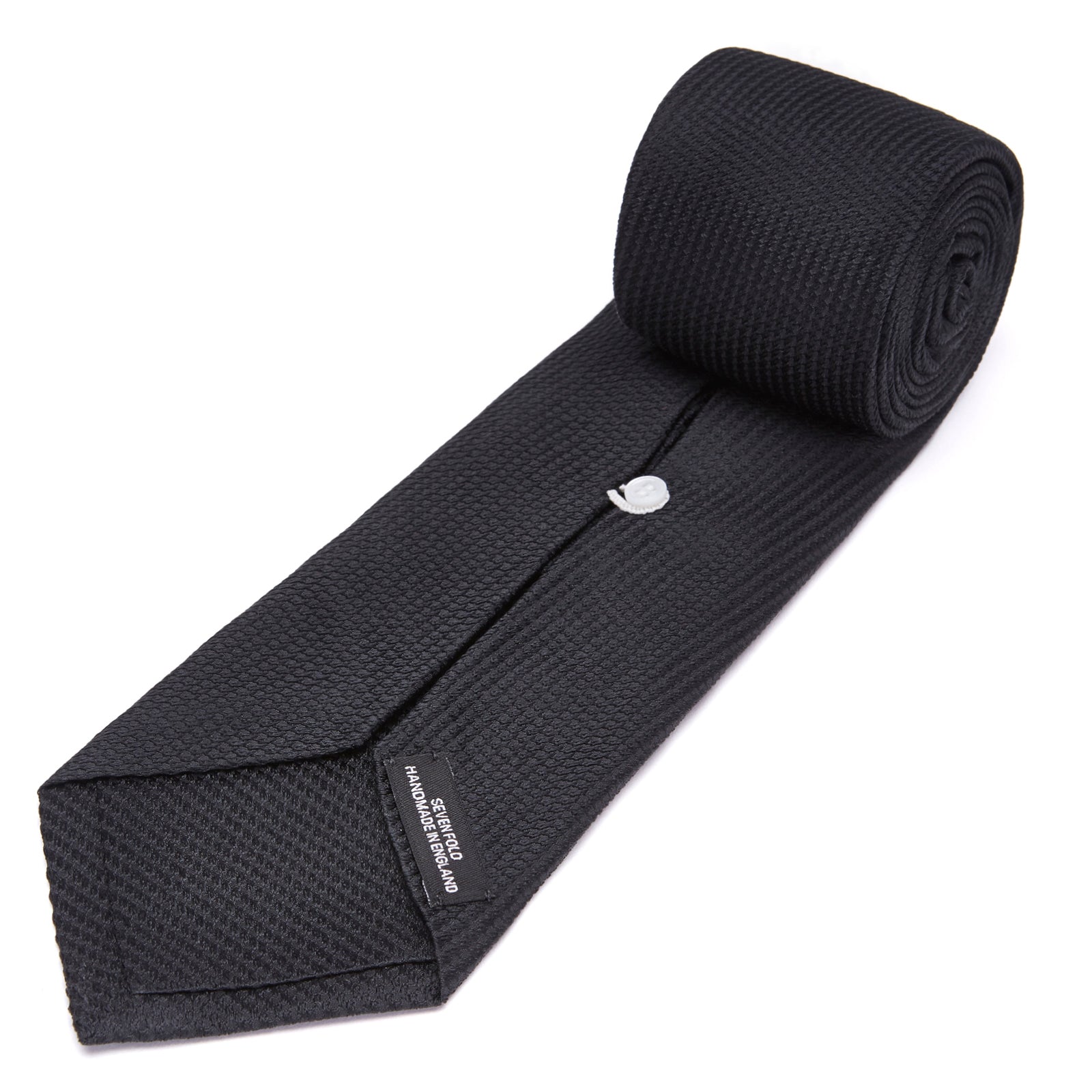 View 4 of product Turnbull & Asser's Seven-Fold Black Lace Silk Tie, featuring a textured finish and pointed tip, is elegantly rolled and displayed on a white background—a timeless accessory for any luxury neckwear collection.