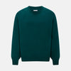 View 1 of product The Turnbull & Asser Moss Green Cashmere Round Neck Jumper, shown on a plain white background, is men's knitwear with long sleeves and a classic design featuring ribbed cuffs, neckline, and hem for timeless style.