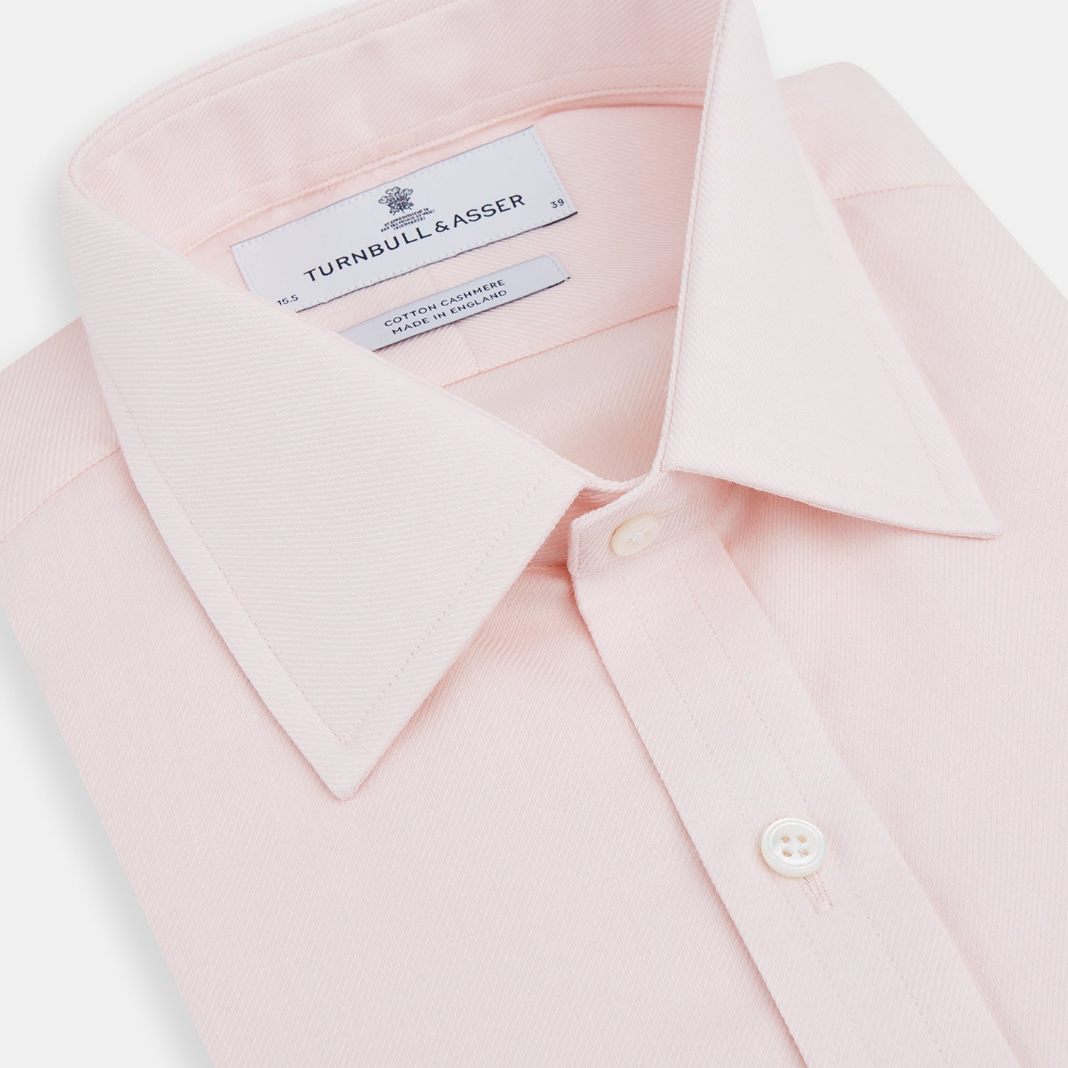 View 2 of product The Pale Pink Cotton Cashmere Mayfair Shirt by Turnbull & Asser features a classic collar, button-down front, and buttoned cuffs, crafted from a luxurious cotton-cashmere blend and displayed flat on a white background.