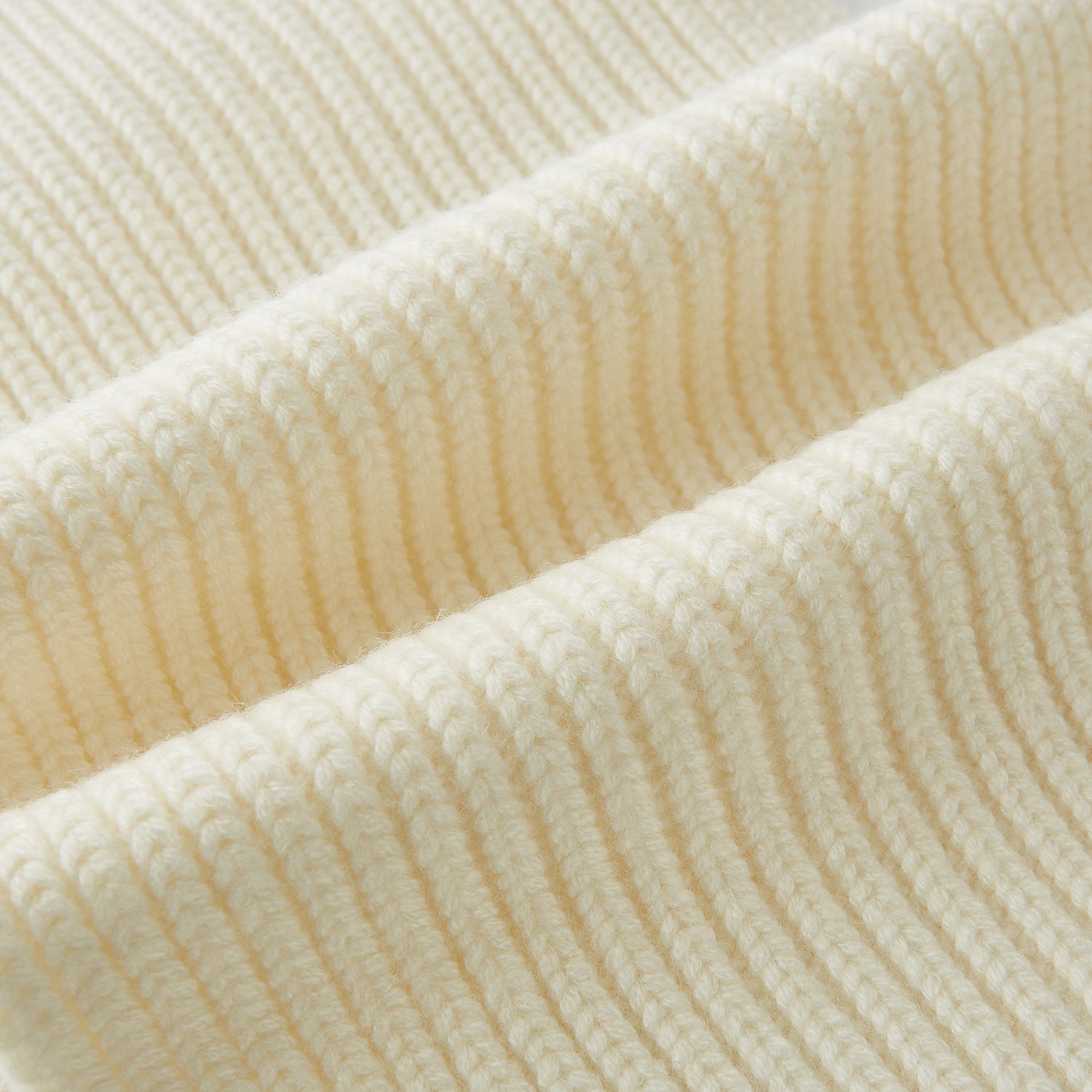 View 3 of product The Turnbull & Asser Ivory Rib-Knit Cashmere Scarf is tied in a simple loop, showing off its textured finish against a plain white background.