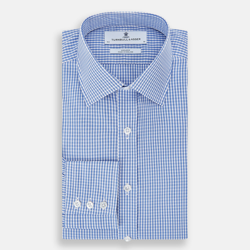 The Turnbull & Asser Blue Multi Micro Check Mayfair Shirt features a classic T&A collar, button-up front, white buttons, cuffed long sleeves, and a refined light blue and white micro check pattern.