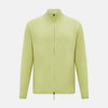 View 1 of product The Melon Green Merino High Neck Zipped Cardigan by Turnbull & Asser features long sleeves and ribbed collar, cuffs, and hem, shown on a plain white background.