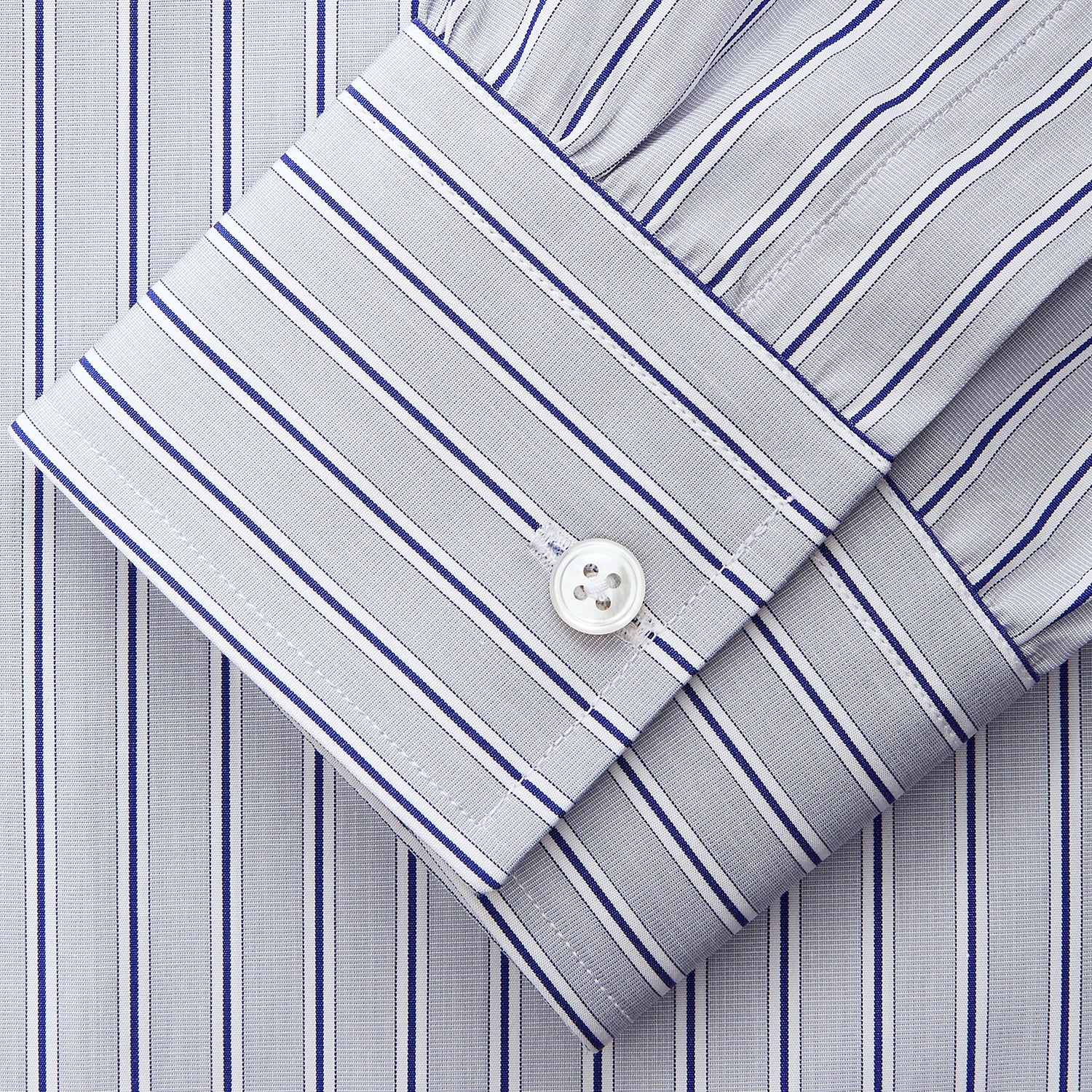View 3 of product Turnbull & Asser Navy & Blue Stripe Weekend Fit Shirt, featuring a Derby collar, single button cuffs, and a chest pocket, laid flat on a white background.