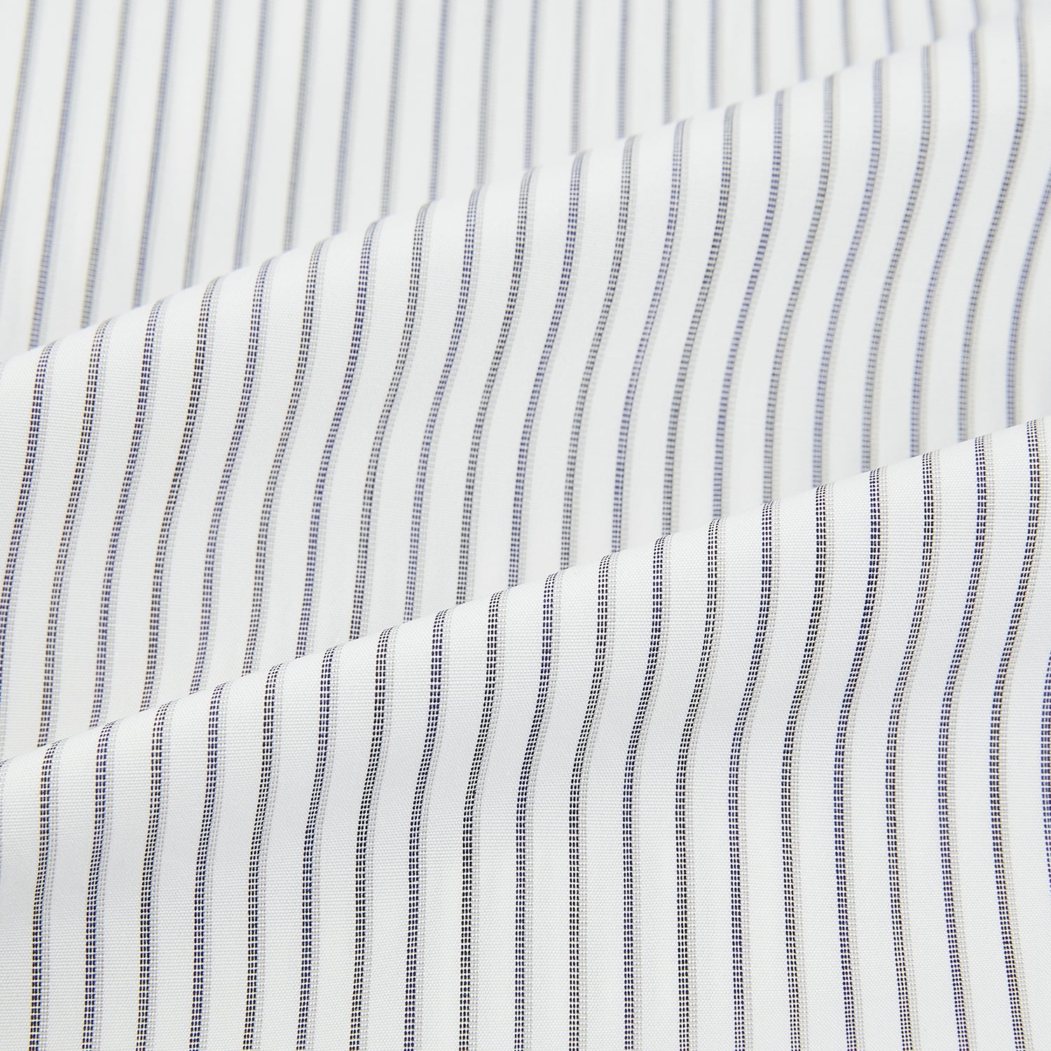 View 6 of product The Navy Music Stripe Mayfair Shirt by Turnbull & Asser features thin vertical blue and white stripes, a classic T&A collar, and long sleeves, shown on a plain white background.