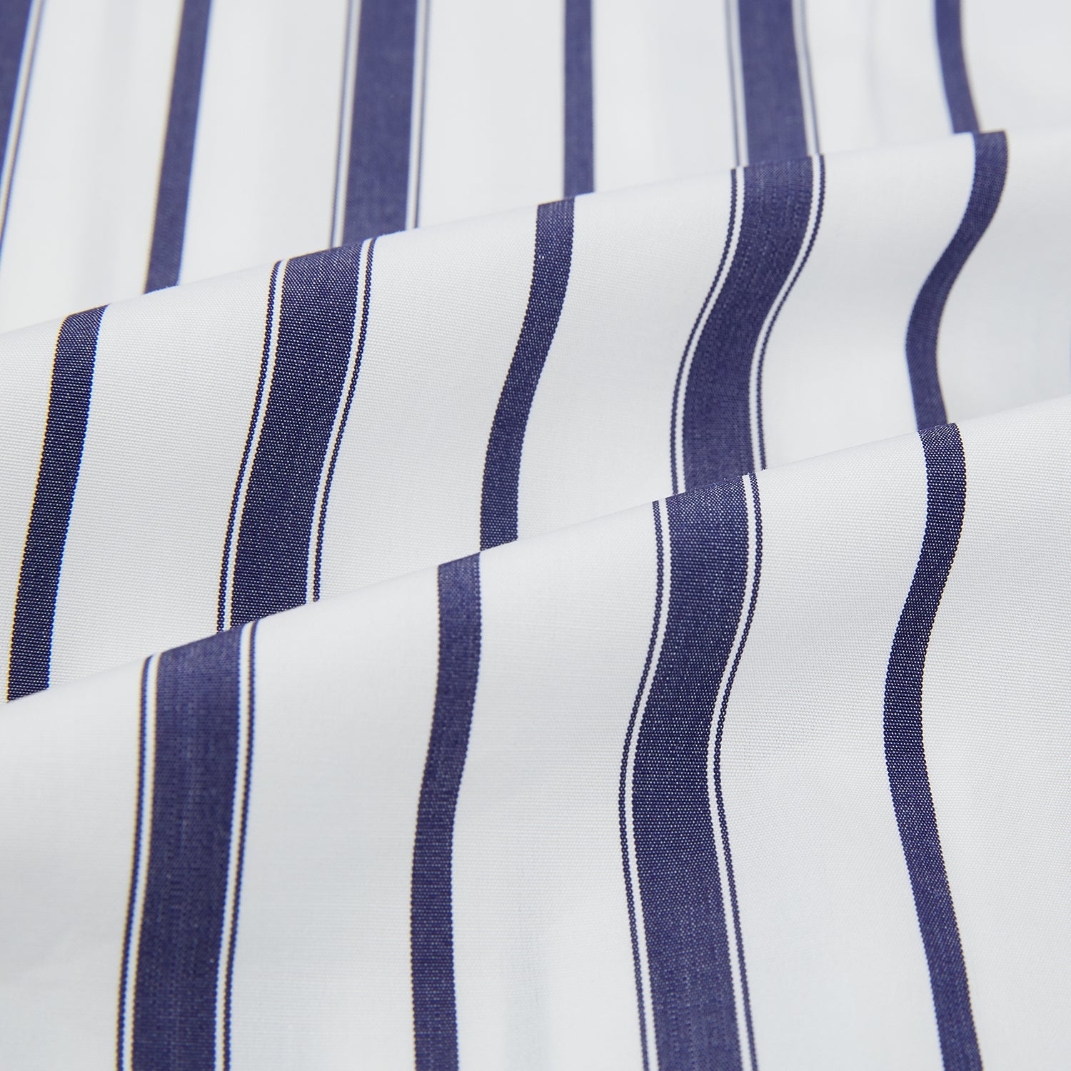 View 5 of product The Turnbull & Asser Navy Double Stripe Quarzo Nightshirt, a knee-length Italian cotton nightshirt with navy and white vertical stripes, collar, chest pocket, and button-down front, is displayed flat on a white background.