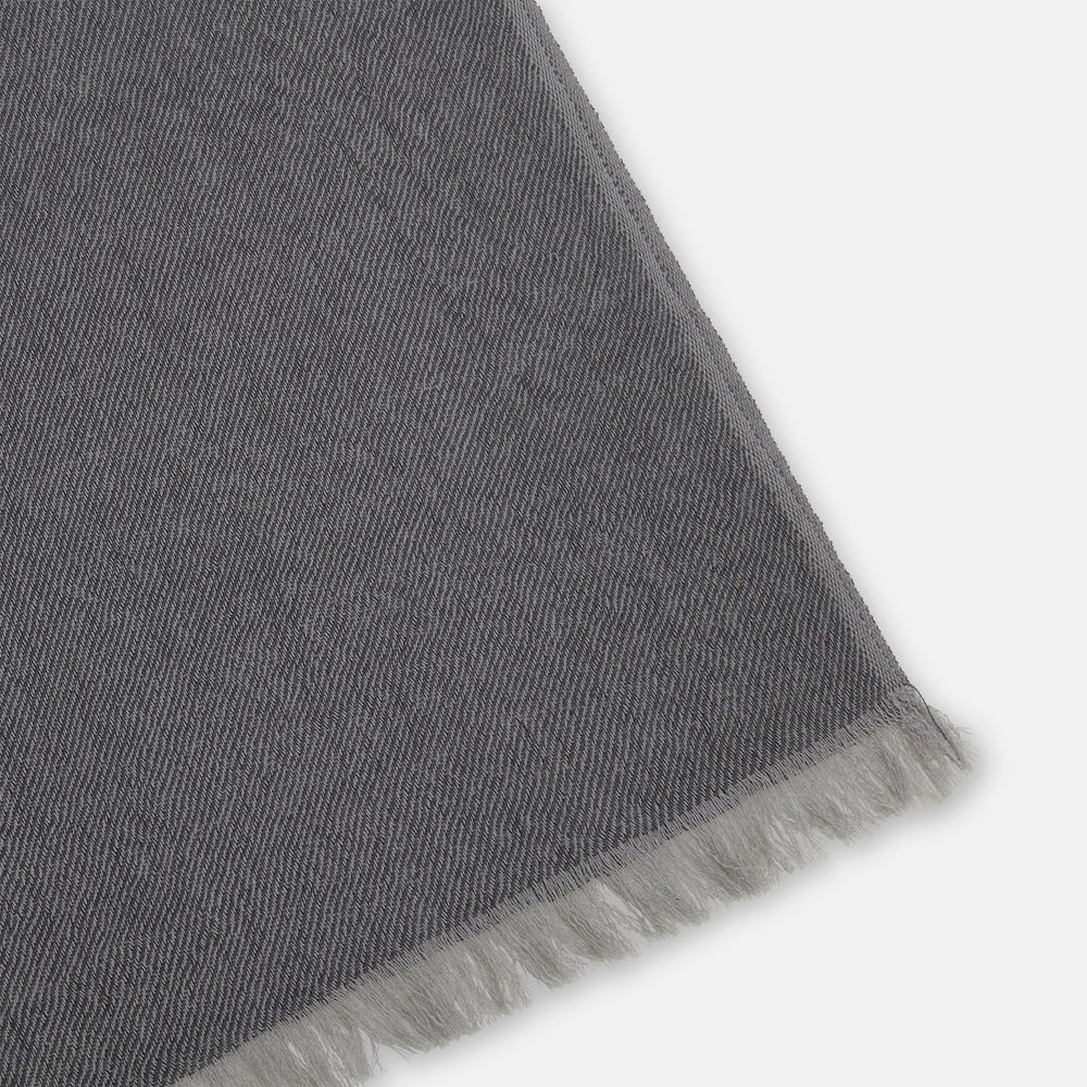 The Turnbull & Asser Grey and Beige Cashmere Scarf features beige, tan, gray, and charcoal color blocks in a rectangular shape with fringed edges at both ends, elegantly displayed against a plain white background.