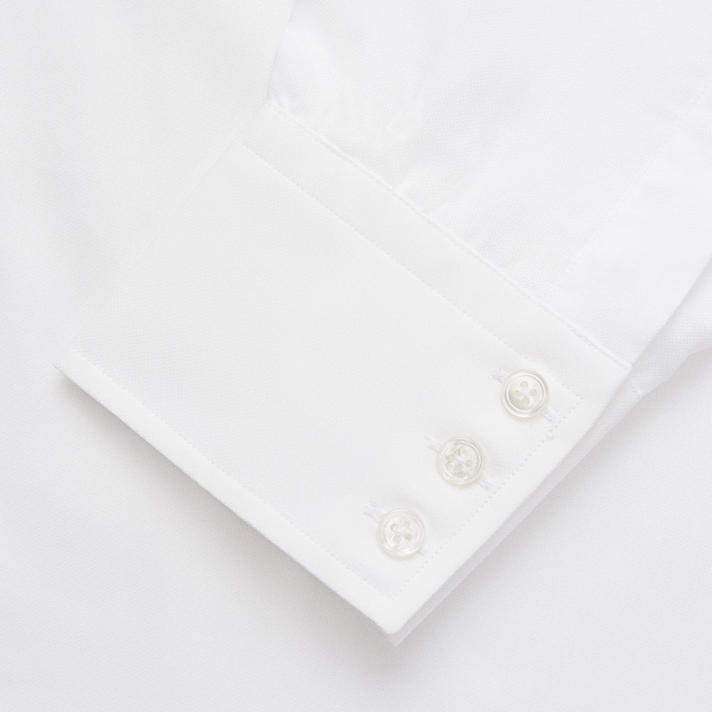 The Turnbull & Asser White Cotton Voile Regular Fit Mayfair Shirt features long sleeves, a pointed collar, button-down front, and buttoned cuffs, displayed flat against a plain white background.