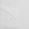 View 4 of product The Turnbull & Asser White Poplin Shirt With Regent Collar and 2-Button Cocktail Cuffs, featuring long sleeves, is buttoned up and laid flat on a white background.