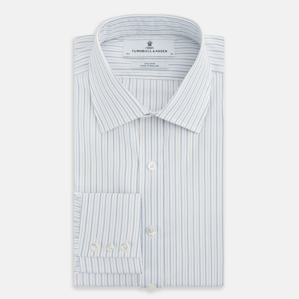 The Turnbull & Asser Sky Blue Combination Stripe Mayfair Shirt features long sleeves, a T&A collar, buttoned cuffs, and thin vertical stripes in blue, shown on a plain white background.