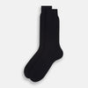 View 2 of product A single Midnight Thick Knit Mid-Length Sock by Turnbull & Asser, crafted from black mercerised Egyptian cotton, is shown in side profile against a plain white background with the toe pointing left.