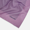 View 2 of product The Lilac Stripe Silk Pocket Square by Turnbull & Asser features thin vertical navy stripes on folded silk, with "TURNBULL & ASSER HAND PRINTED IN ENGLAND" inscribed in the bottom right corner, reflecting British heritage.