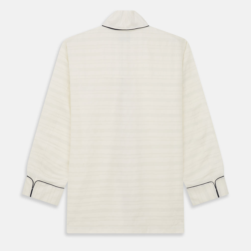 The Cream Pattern Cotton Blend Quin Pyjama Set by Turnbull & Asser features cream stripes, a long-sleeve button-up camp collar shirt with a chest pocket and black piping, and matching drawstring pants.
