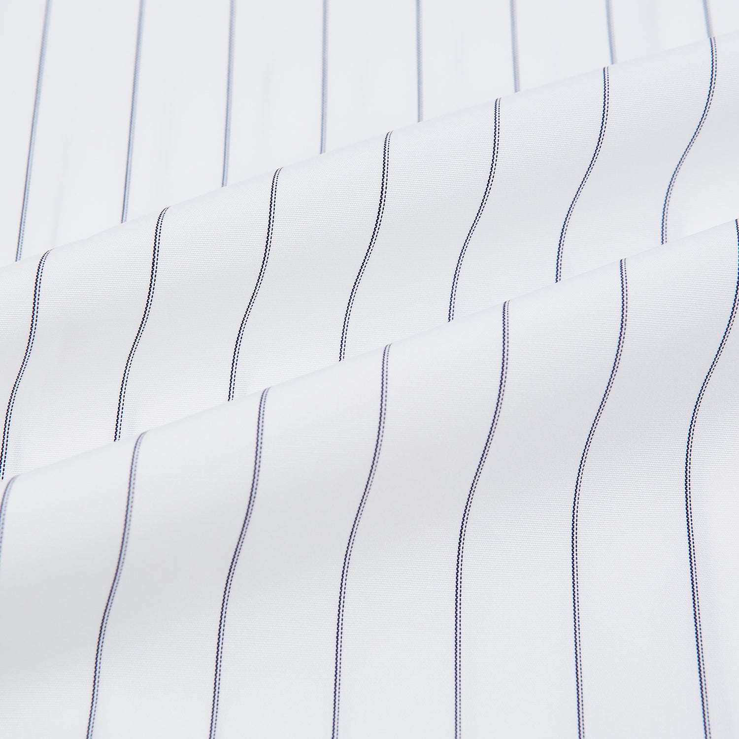 View 6 of product The Turnbull & Asser Navy Hairline Multi Stripe Mayfair Shirt, made from fine Italian cotton with navy stripes, a pointed collar, and buttoned cuffs, is shown laid flat on a plain white background.