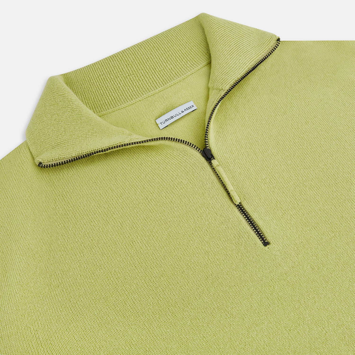 View 2 of product The Turnbull & Asser Melon Green Half-Zip Cashmere Jumper features long sleeves, a high collar, and half-zip front—ideal knitwear for layering. Shown on a plain white background.