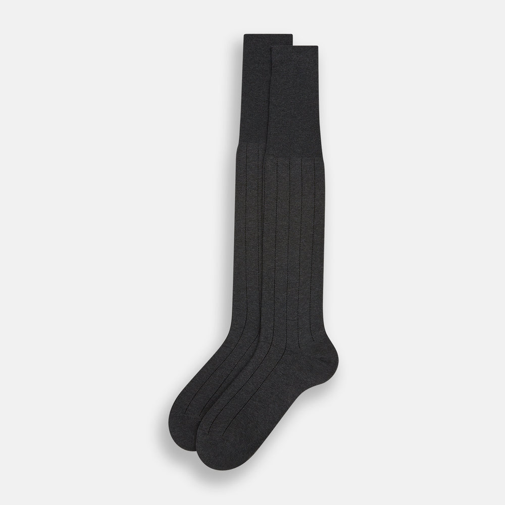 A single Charcoal/Brown Dash Striped Long Sock by Turnbull & Asser, made from mercerised Egyptian cotton, stands upright on a plain light background, showcasing its ribbed texture and fitted design.