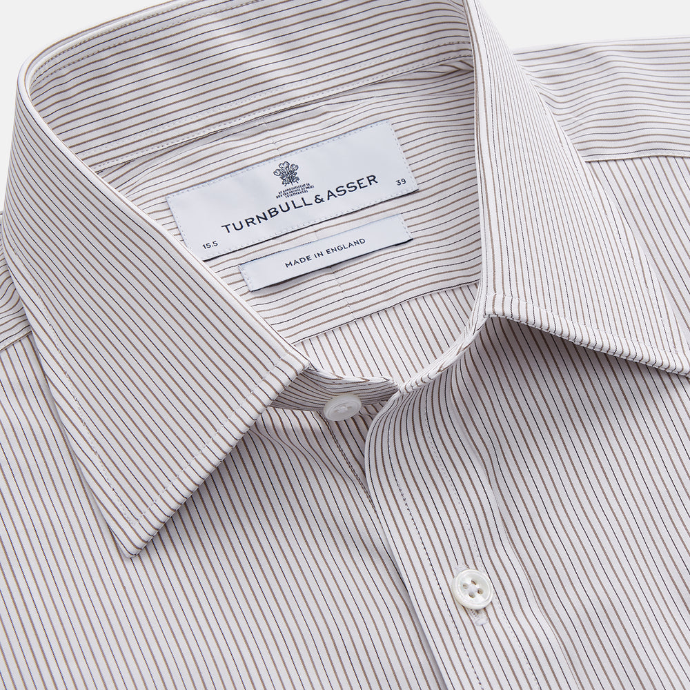The Turnbull & Asser Sandstone Multi Stripe Cotton Regular Fit Mayfair Shirt, featuring long sleeves, button-up front, chest pocket, and classic collar with subtle white and light gray vertical pinstripes, is laid flat on a white background.