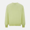 View 3 of product The Turnbull & Asser Pistachio Cashmere V-neck Jumper features long sleeves, ribbed cuffs and hem. Shown in light green against a white background, it's a classic addition to any knitwear collection.