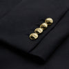 View 4 of product The Turnbull & Asser Navy Plain Wool Double Breasted Blazer features a nautical-inspired design with gold buttons, peaked lapels, and flap pockets, shown against a white background.