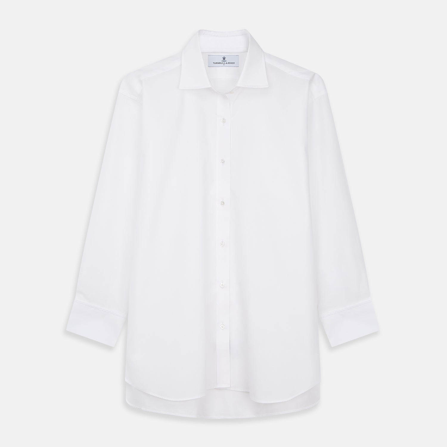 View 2 of product A woman with straight brown hair pulled back wears the Turnbull & Asser White Cotton Marlene Shirt, featuring classic menswear details, paired with high-waisted cream trousers against a neutral background.
