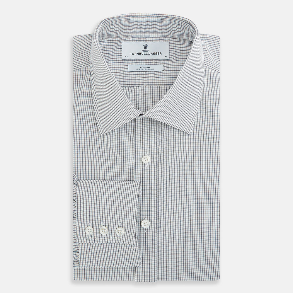 The Midnight Blue Micro Tattersall Check Mayfair Shirt by Turnbull & Asser, made from pure cotton with white buttons, a classic collar, and cuffed sleeves, is laid flat on a white background.