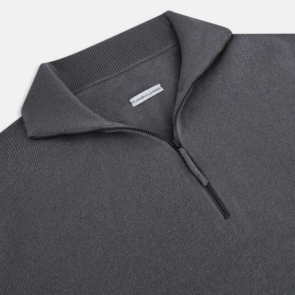 The Turnbull & Asser Grey Half-Zip Cashmere Jumper features long sleeves, a high collar, and premium yarn in dark gray. This classic knitwear is showcased against a white background.