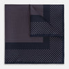View 1 of product The Turnbull & Asser Navy and Pink Dot Silk Pocket Square features small pink dots and a solid border, with one corner folded to display both sides—an elegant accessory that reflects fine handmade craftsmanship.