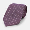 View 1 of product The Turnbull & Asser Lilac and Purple Micro Dot Silk Tie, featuring small white dots, is a stylish accessory for smart attire. Displayed rolled-up on a light background.