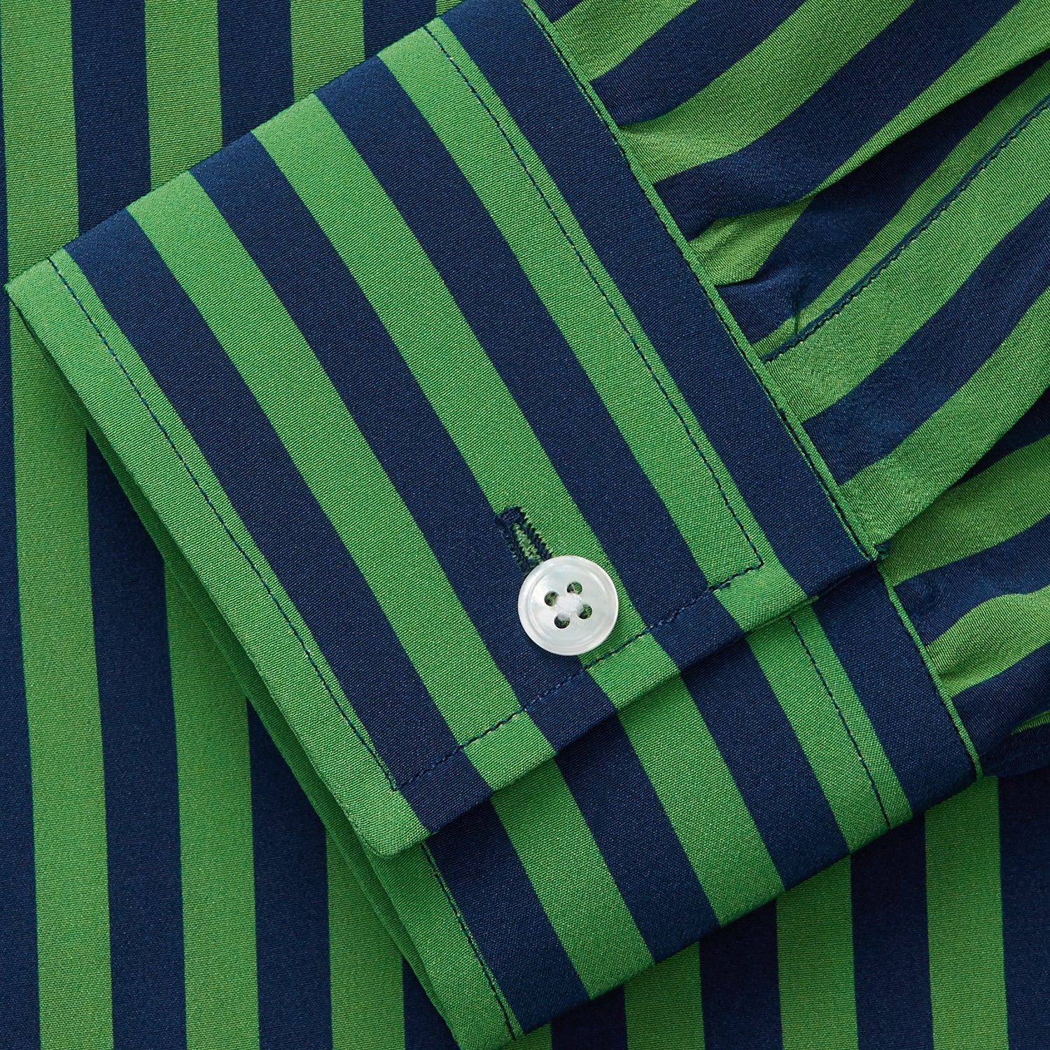 View 2 of product The Turnbull & Asser Green and Navy Candy Stripe Silk Weekend Fit Harold Shirt features long sleeves, a button-up front, collar, and cuffs, displayed laid flat on a white background.