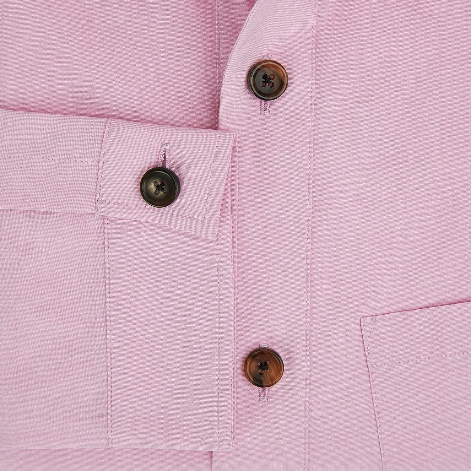 View 4 of product The Pink Hyde Overshirt by Turnbull & Asser is a long-sleeved, light pink sanforised cotton shirt with a left chest pocket and dark buttons—an elegant, laid-back alternative to a blazer.