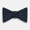 View 1 of product The Turnbull & Asser Lime Green and Sky Blue Spot Silk Bow Tie features a textured navy background with light blue and lime green polka dots, shown on a white background—a timeless men's accessory.