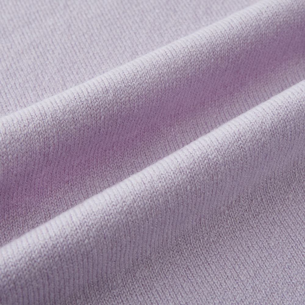 The Turnbull & Asser Plain Lilac Cashmere Knitted Scarf is shown neatly tied in a loose knot against a plain white background, highlighting its elegant and timeless design.