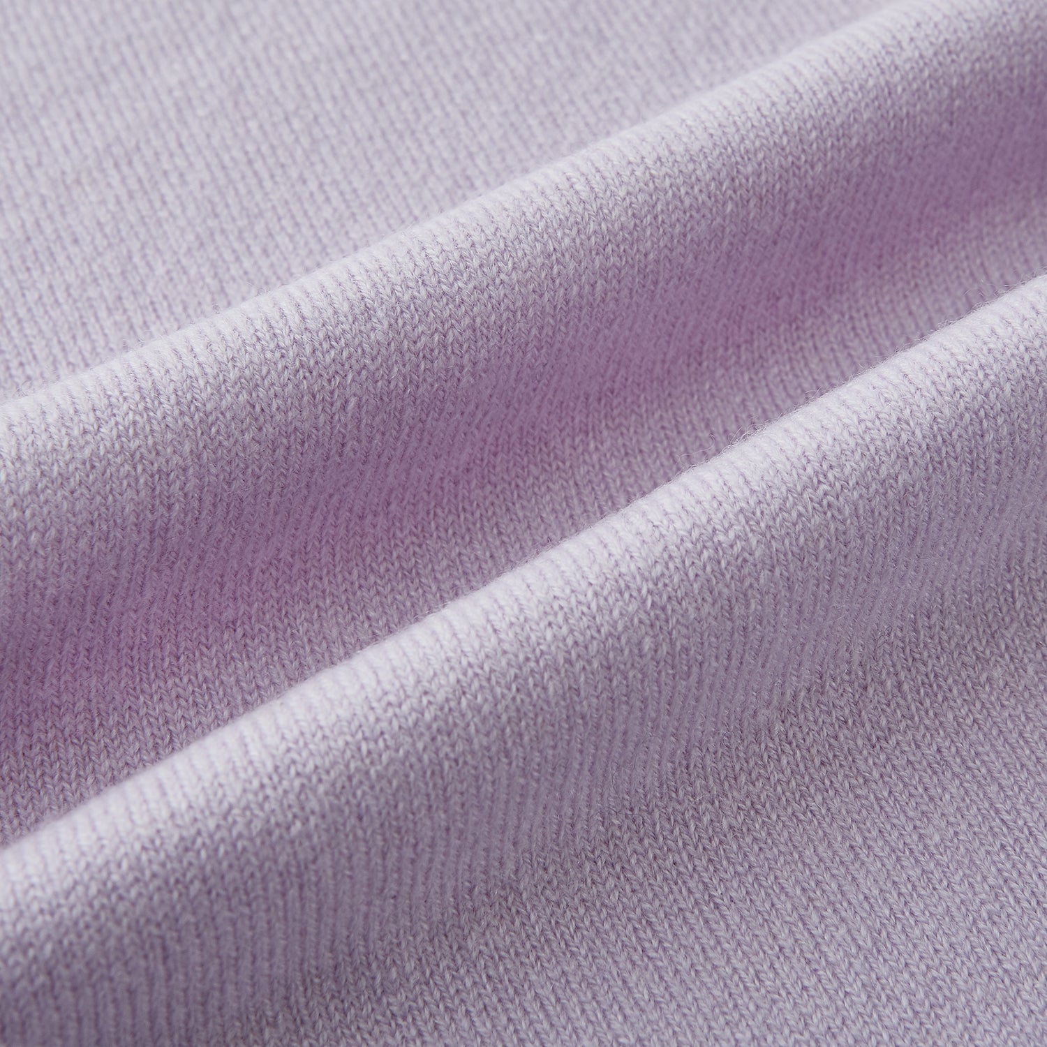 View 3 of product The Turnbull & Asser Plain Lilac Cashmere Knitted Scarf is shown neatly tied in a loose knot against a plain white background, highlighting its elegant and timeless design.