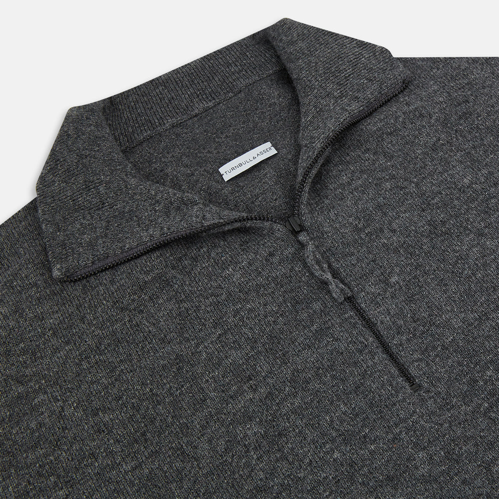 The Turnbull & Asser Charcoal Grey Melange Half-Zip Cashmere Jumper features a high collar, quarter-zip design, and long sleeves, shown against a plain white background.