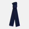View 1 of product The Turnbull & Asser Navy Cashmere Scarf features a subtle texture and frayed edges, loosely knotted at the top and displayed against a plain white background.