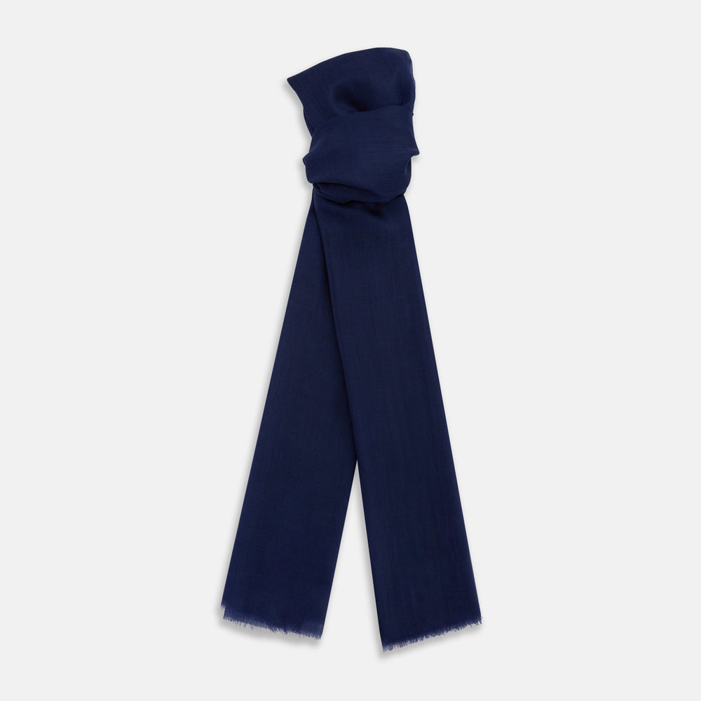 The Turnbull & Asser Navy Cashmere Scarf features a subtle texture and frayed edges, loosely knotted at the top and displayed against a plain white background.