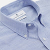 View 2 of product The Turnbull & Asser Mid-Blue Chambray Weekend Fit Shirt features a Dorset collar, white buttons, and 1-button cuffs. It is laid flat on a white background.