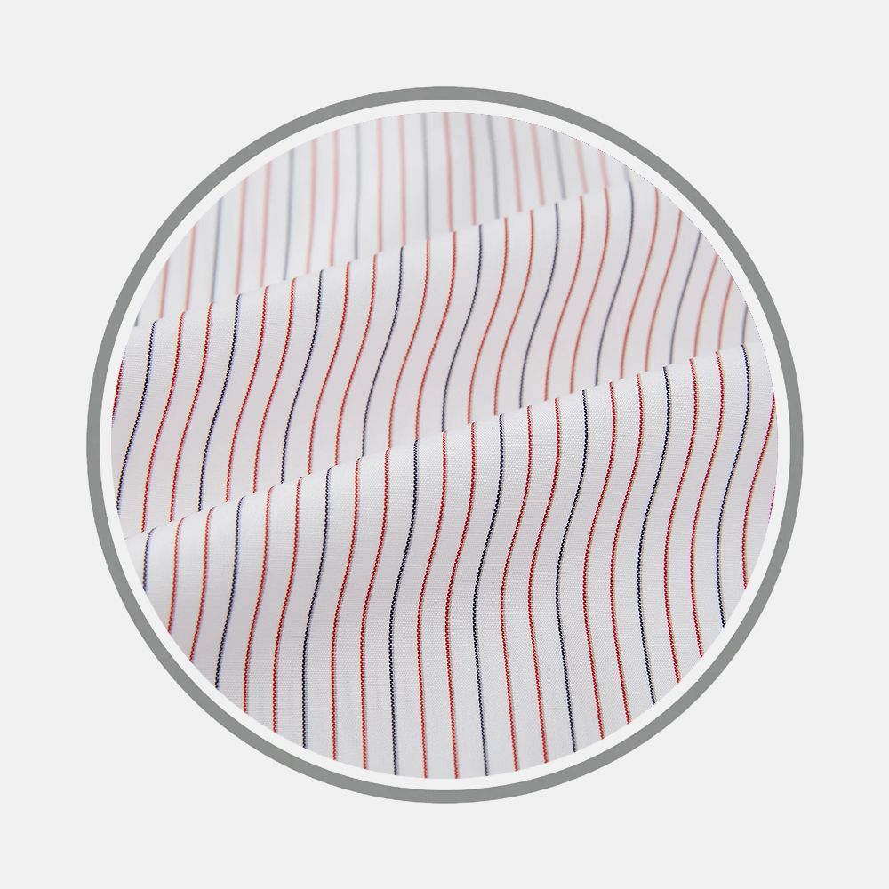 Close-up of Turnbull & Asser Red and Blue Ticking Stripe Fabric, featuring evenly spaced vertical red and navy stripes on white, displayed in a circular frame against a light background.