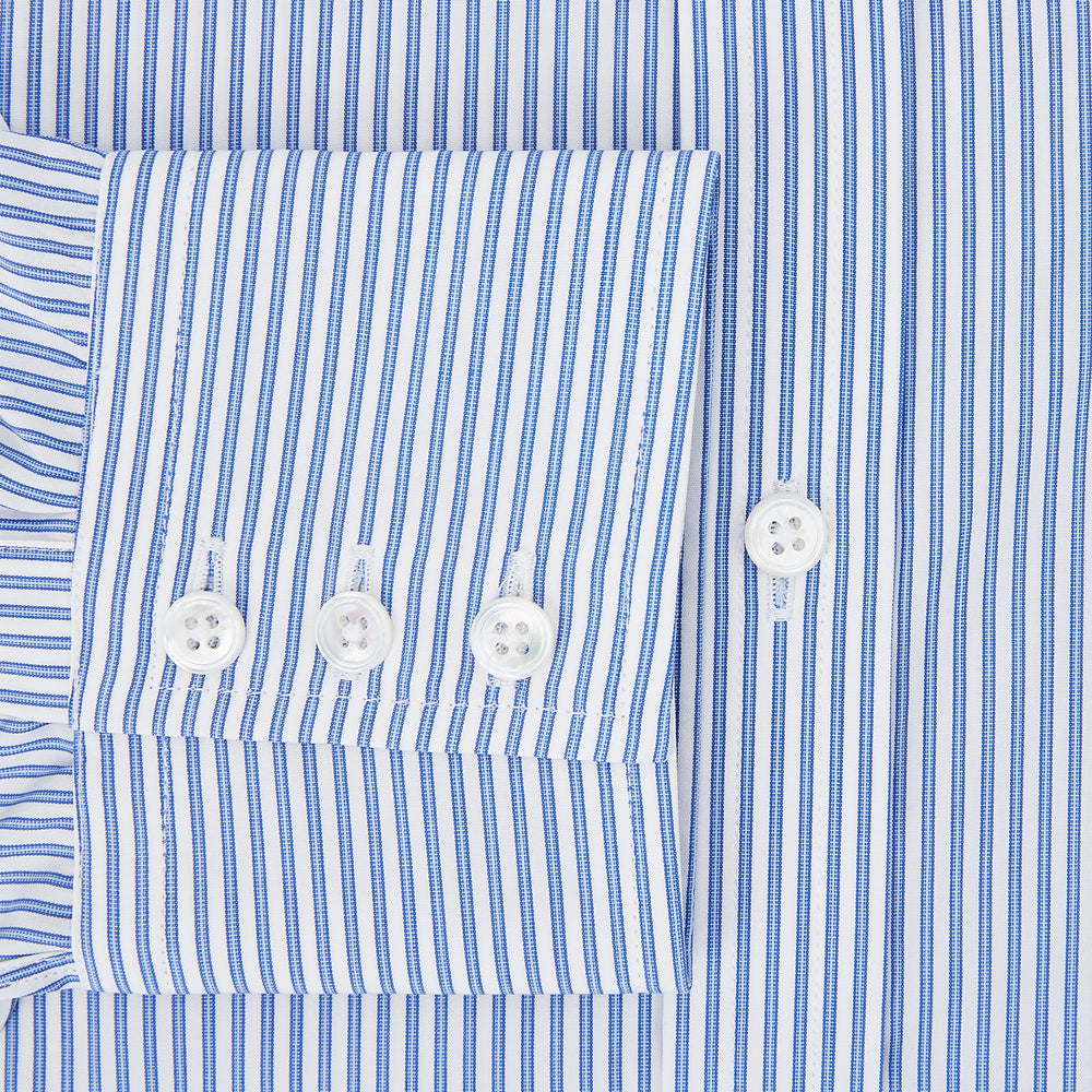 The Sky Blue Halo Stripe Mayfair Shirt by Turnbull & Asser, a long-sleeved button-up with thin blue and white vertical stripes, classic collar and cuffs, is shown laid flat on a white background.