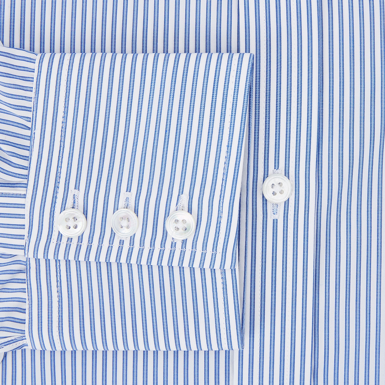 View 4 of product The Sky Blue Halo Stripe Mayfair Shirt by Turnbull & Asser, a long-sleeved button-up with thin blue and white vertical stripes, classic collar and cuffs, is shown laid flat on a white background.
