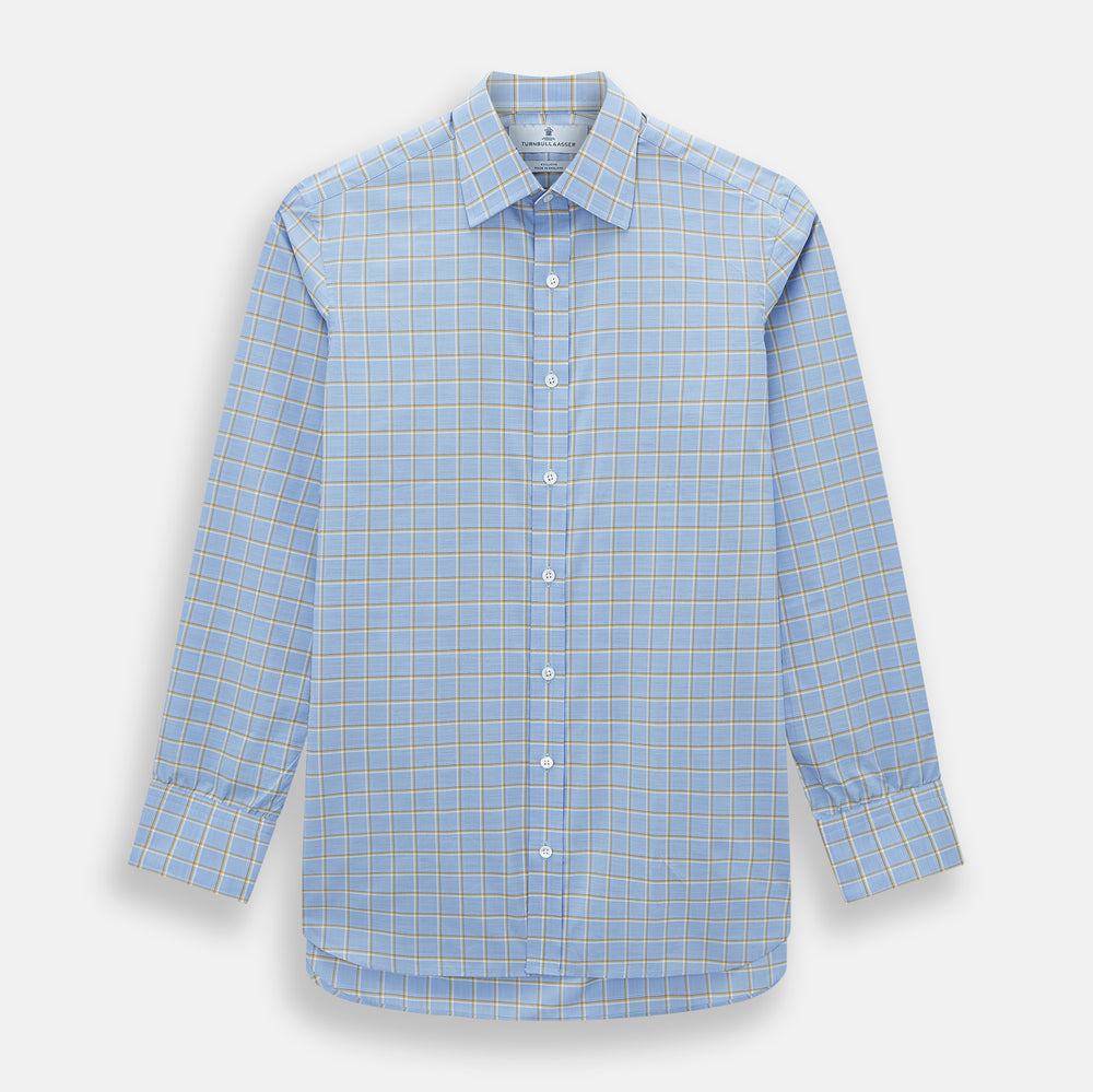 The Turnbull & Asser Blue and Yellow Windowpane Mayfair Shirt is crafted from fine Italian cotton, featuring a light blue base with yellow and white checks, shown on a plain white background.