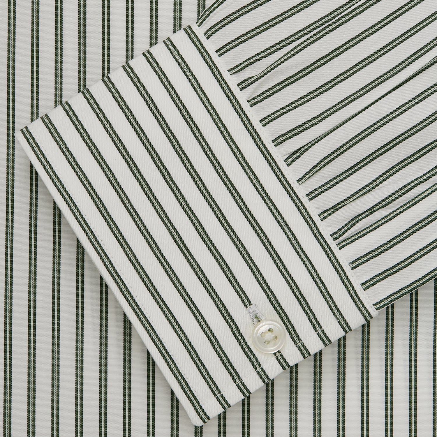 View 5 of product The Turnbull & Asser Green Stripe Weekend Fit Shirt features a derby collar, 1-button cuffs, and relaxed fit, perfect for smart-casual style, shown laid flat on a white background.