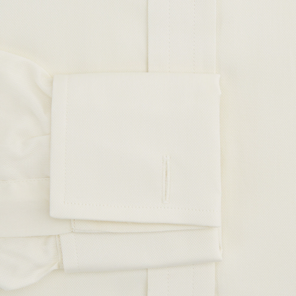 The Turnbull & Asser Tomorrow Never Dies Cream Cotton Hamburg Shirt, as seen on James Bond, features a long sleeve, button-down front, and collar. It's laid flat on a white background.